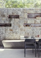 Display of ornament set in alcoves of stone wall of dining room