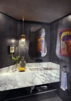Contemporary bathroom with white marble sink and black walls