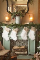 Fireplace decorated for Christmas with handmade stockings