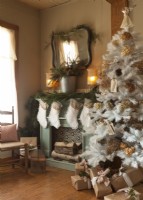Christmas fireplace with stockings, tree and gifts