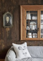 Wooden alcove cupboard on wall of country living room