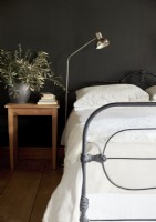 Olive branches in vase in black and white country bedroom