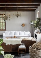 White sofa and candle chandeliers in modern country living room