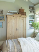 A vintage pine armoire offers much needed storage with charm.