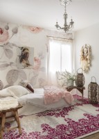 A rose motif wallpaper, dream catcher and a tapestry-style rug bring a romantic boho vibe to the guest bedroom.a 