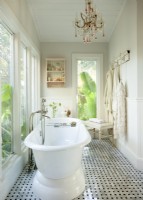 Borrowing space from a former balcony and enclosing it provided room for a stand-alone tub and an additional dressing area. Marble floors add a touch of luxury and a spa-like mood. 