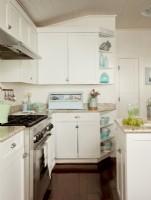 The completely redone kitchen gave Nikki a chance to come up with the just the right finishes to complement the rest of the house, like the white cabinetry, stainless appliances and blue accents. 