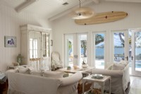 In the family room, a wall of windows and double doors allows a the view of the back of the home and the bay beyond.