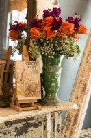 Renee is an avid gardener and reaps the benefits with colorful blooms.
A small easel displays  a vintage book about the old city of New Orleans. 