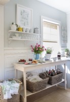 Rachel fashioned a pair of narrow shelves from long marble pieces. A narrow sideboard constructed from 2â€™x4â€™s and pine planks provides a work area and storage for stylish baskets with a small footprint.