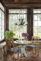 Light streams from many windows to fill the living room, once an old brick porch housing orchids in winter. 
The cozy corner table offers a quiet spot for breakfast or tea for two. 