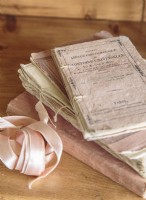In the guest bedroom, Kathy displays favorite vintage items like old French books united by their faded pink covers.