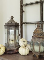 In keeping with Kayla's fall theme, gourds nestles in and around rustic lanterns on the dining room sideboard.