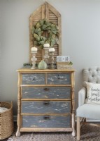 Kayla usually rescues and refinishes the furniture for her home, but she bought this redone bedroom chest from a friend. â€œThe contrast between the bare wood and the gray chalk-painted drawers with the original hardware really spoke to me.â€She  says. A magnolia wreath hangs on a pair of antique European shutters. 