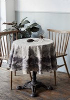 Cream fabric tablecloth on small round table 