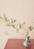 White branches in small ceramic vase