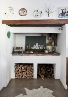 Log store under built-in unit in Mediterranean style country kitchen