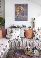 Patterned colourful cushions and fabrics in modern living room