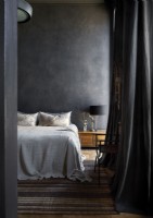 Black painted wall in country bedroom