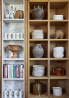 Detail of shelving units with crockery, books and ornaments