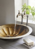 Small bowl sink and brass taps running water