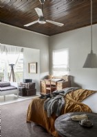 Wooden ceiling with fan in country bedroom