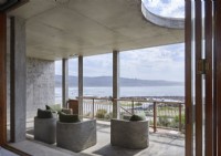 Concrete furniture on contemporary balcony with sea views