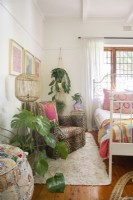 Girl's bedroom with plants and leopard print upholstered armchair