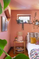 Bedroom with electic decor and pink walls