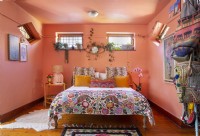 Bedroom with eclectic decor and pink walls