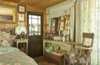 An imposing antique mirror adds dimension to the guest bedroom.