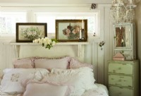 A fireplace mantel turned headboard offers a shelf for vintage paintings that share the linensâ€™ patterns and hues.