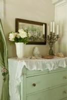 The vintage dresser has been refreshed and given a new life with a coat of pale green paint. 