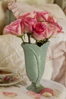 A original McCoy vase with a leaf design makes a perfect container for fresh flowers.