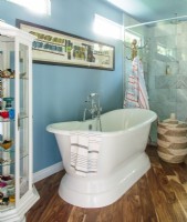 The remodeled bathroom's focal point is a freestanding bathtub adjacent to the glassed-in shower