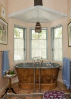 The master bath's focal point is a 19th century zinc-lined copper tub made in Paris in the 1860s. 