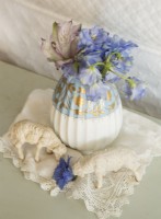 Gentle accessories, like this delicate vase and sheep figurines, bring softness to the country decor.