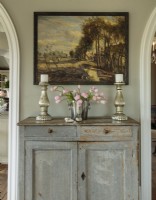 This primitive cupboard is
a Swedish antique. It tucks neatly into a corner of the dining room, lending its simple beauty along with extra storage.