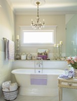 The master bath, with its freestanding tub, heirloom chandelier and an array of French accents makes it easy to imagine you are soaking away your cares in Provence