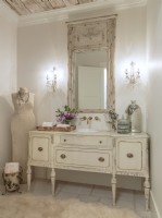 A fanciful French dresser converts to a practical bathroom vanity when a sink basin is dropped in.