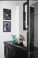 Vanity and artwork in modern black and white bathroom 