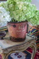 An old lard bucket makes a charming vessel for flowers.