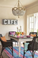 In the dining room, an exotic rug sets off the dark wicker chairs. By keeping things simple and livable, the Fidels have created a space that feels real, not contrived.