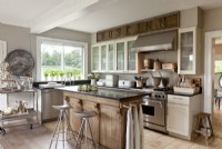 The family-style kitchen was created by joining two rooms together. The island, and old oak counter from Belgium, provides a subtle separation between the cooking and dining areas. 
