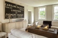 A graphic farm sign makes a strategic focal point. Vintage chairs are elegantly clad in prized French fabric. 
