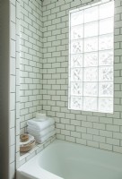 Subway tile with dark gray grout and glass block make every day feel like a stay at a boutique hotel. 