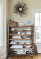  An antique shoe rack stores linens and ironstone within reach.