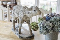 A lamb garden statue adds a playful touch and pastoral feel.