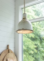 Vintage metal pendants illuminate the kitchen work spaces.