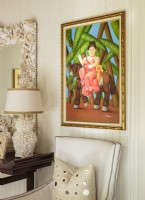 Colorful paintings and shells imbue very space with island flair.